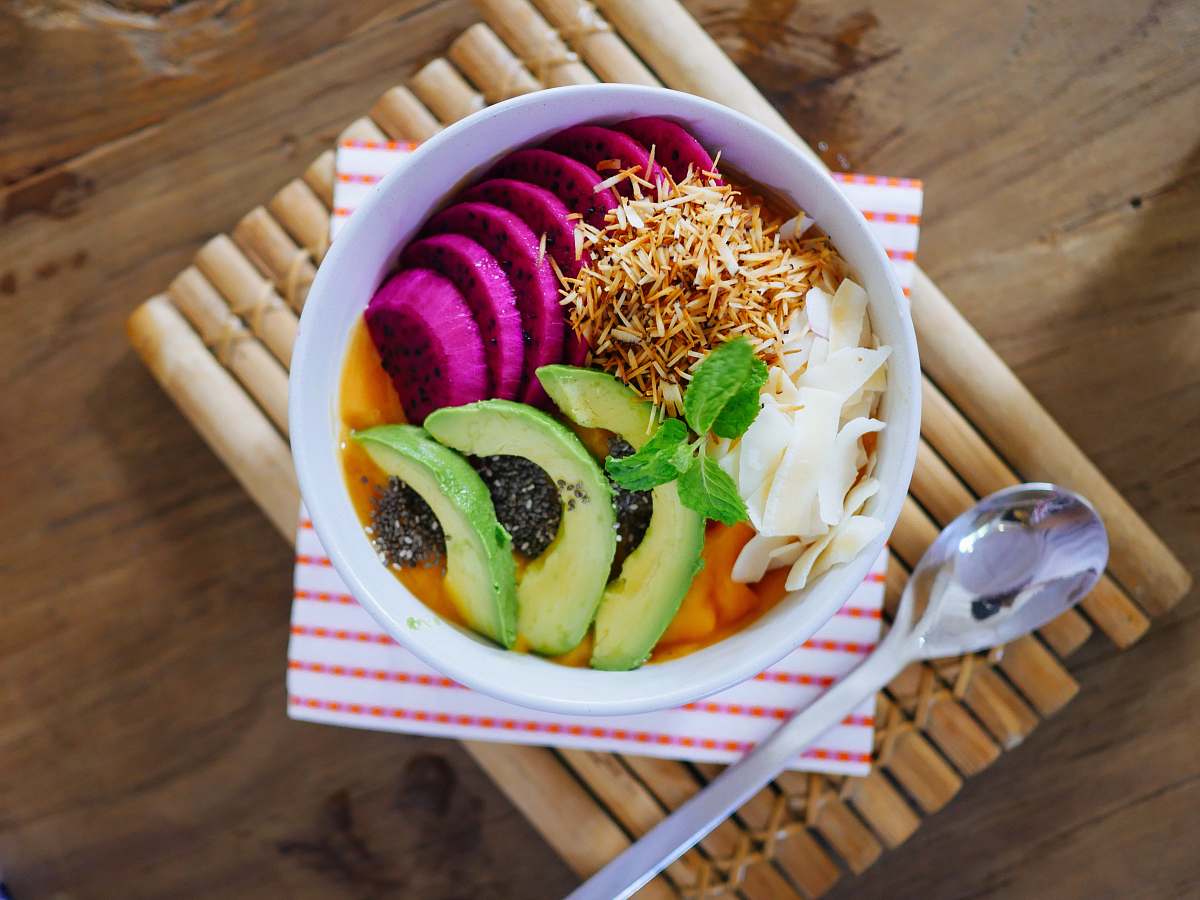 chiang mai sliced fruits on bowl beside gray spoon thailand